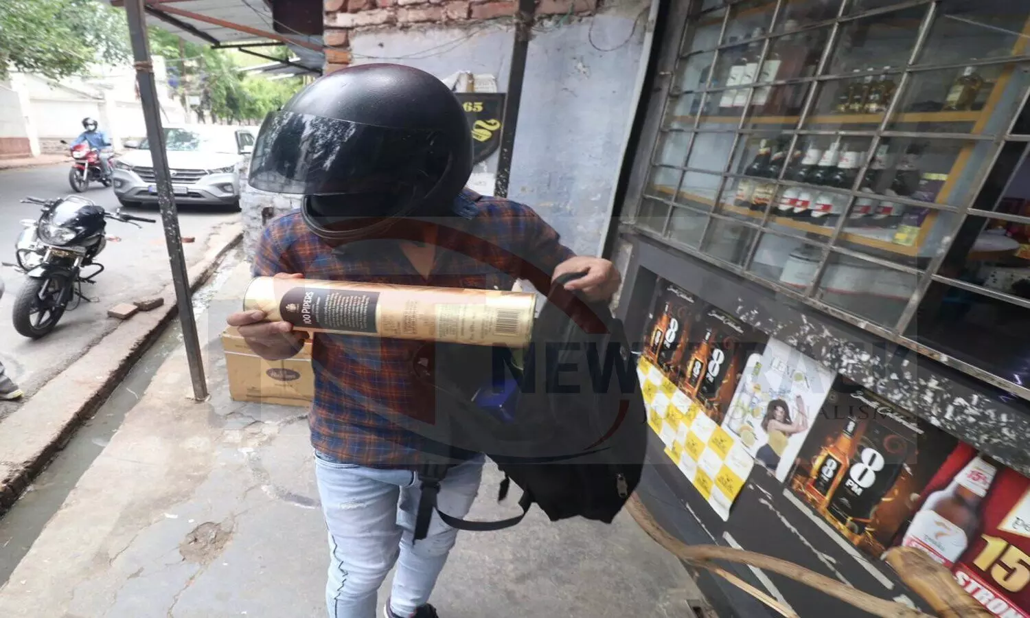 Customer takes liquor from the shop