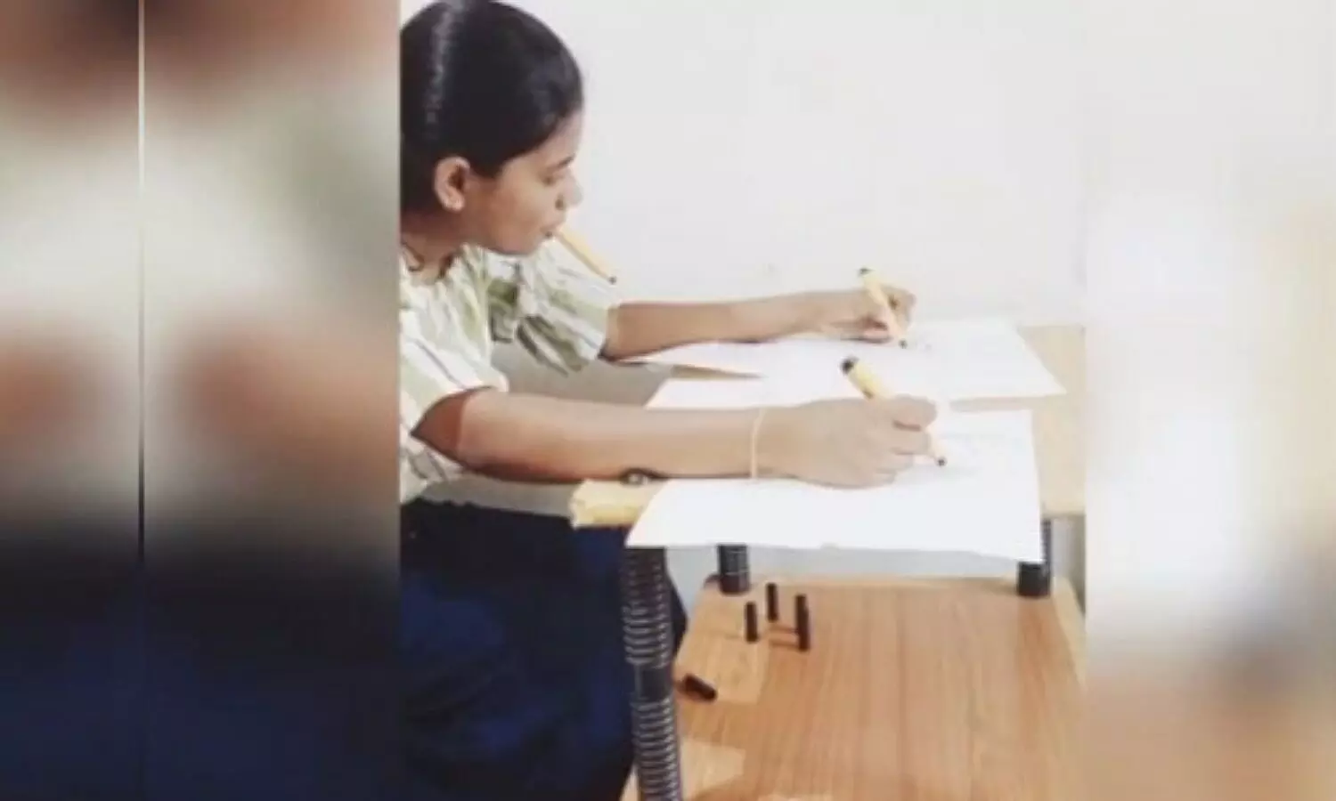 Kerala girl drawing with her hands, feet and mouth