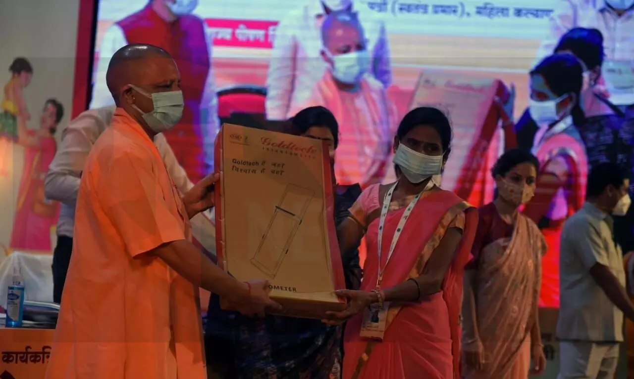 CM Yogi gave mobile phone under nutrition campaign to connect Anganwadi women with technology.