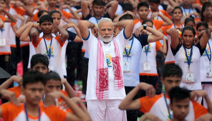 pm modi yoga poses on international yoga day in lucknow