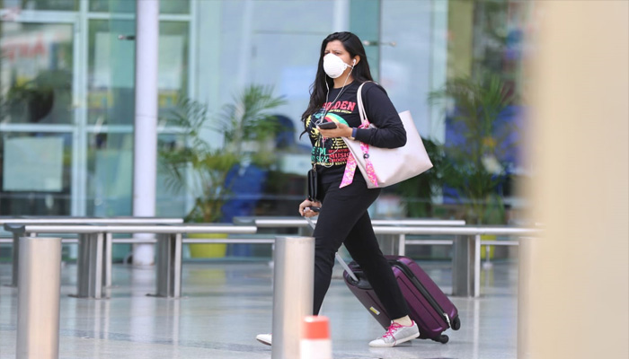 लखनऊ एयरपोर्ट पर कोरोना वायरस से बचने के लिए मास्क पहने यात्री व सुरक्षाकर्मी